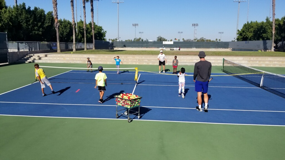 group of people playing tennis