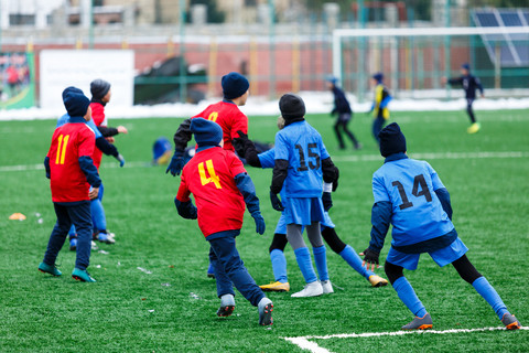 kids playing soccer in the cold kids playing soccer in the cold