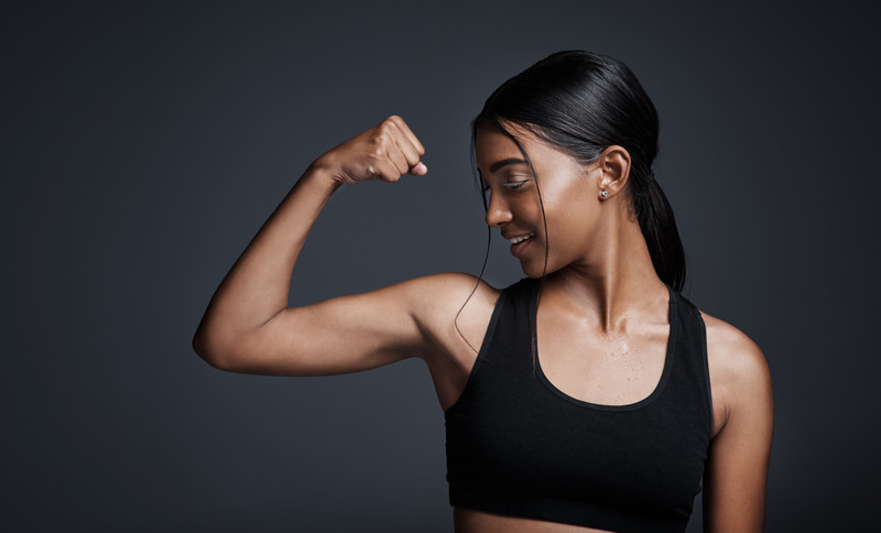 Sports, smile and woman flexing bicep Sports, smile and woman flexing bicep