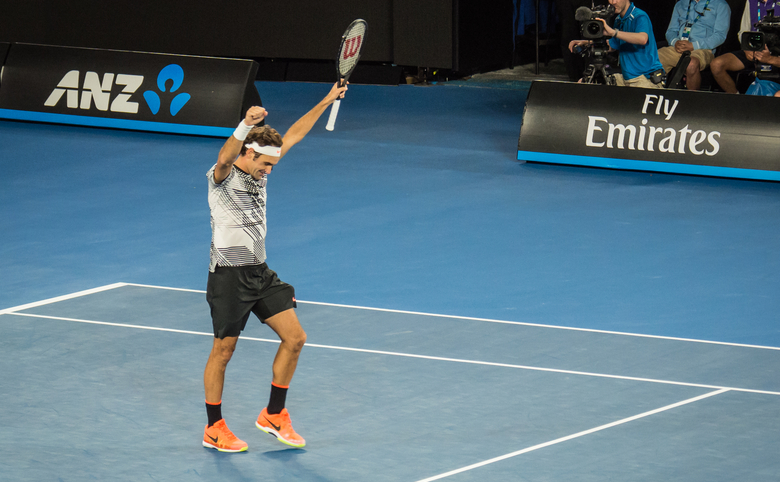 Roger Federer raising his arms in victory