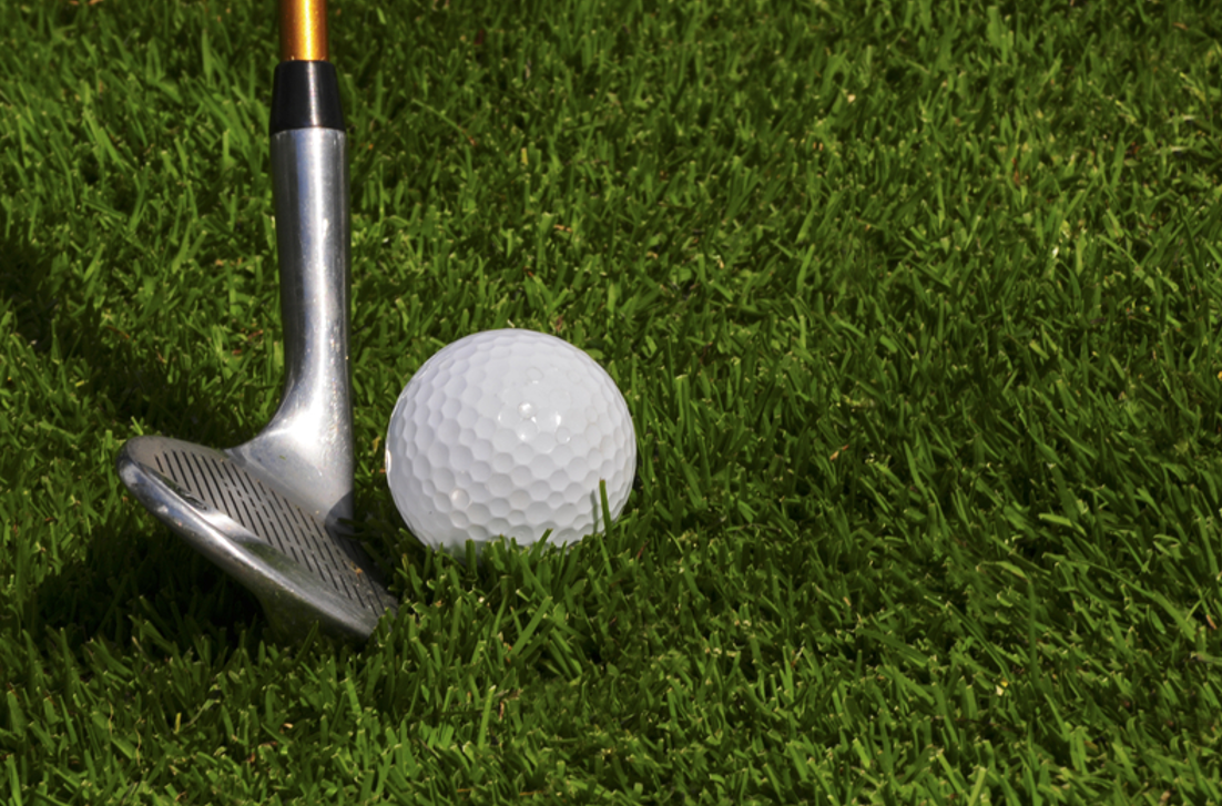 Golfing. Pitching wedge and ball trying to get the ball on the green