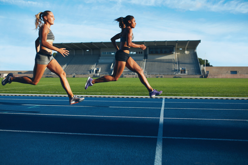 Athletes arrives at finish line on racetrack during training session