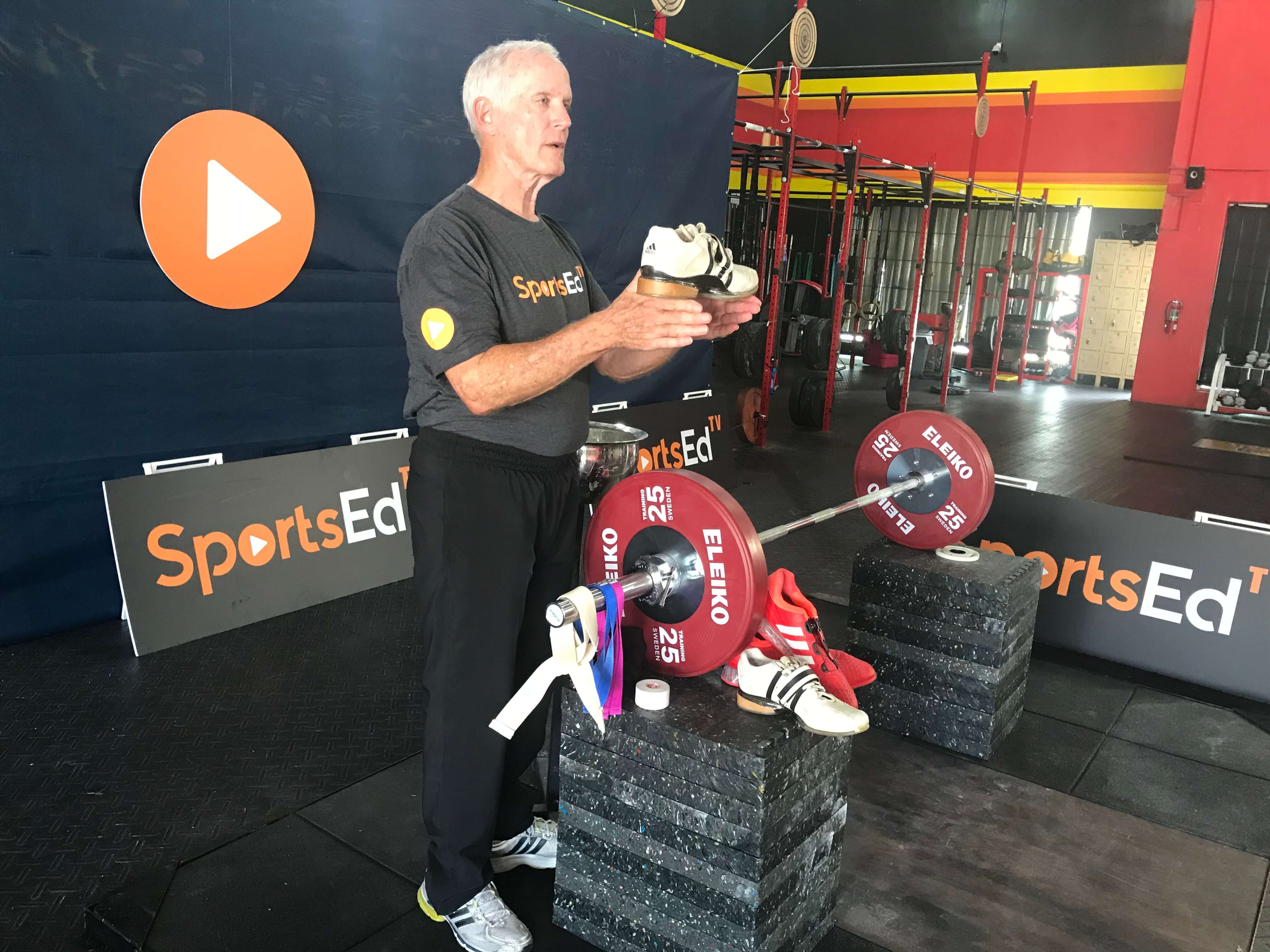 trainer holding weightlifting shoe